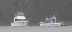 Police boat visiting boaters in Fame Cove